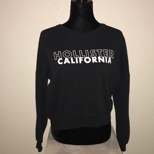 Black Hollister sweater with white writing